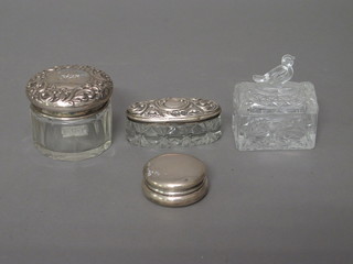 A circular silver rouge pot 1", a cut glass dressing table jar with silver lid, a boat shaped jar with lid and a pressed glass jar with  lid