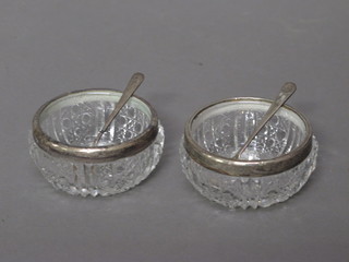 A pair of circular cut glass salts with silver mounts, London 1913
