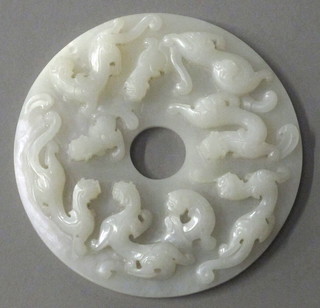 A circular carved Oriental "jade" panel depicting dragons 5"