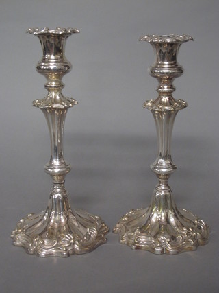 A pair of Rococo style silver plated candlesticks 11"
