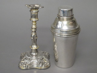 A silver plated cocktail shaker and a silver plated candlestick
