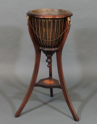 A circular inlaid mahogany planter, raised on outswept supports