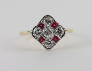 An 18ct yellow gold dress ring set 4 square cut rubies supported  by diamonds