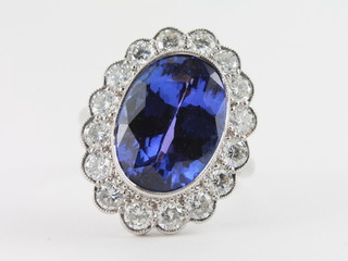 A lady's 18ct white gold dress ring set a large oval cut tanzanite approx 10.20ct surrounded by diamonds, approx 1.80ct