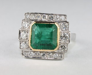 A lady's 18ct white gold dress ring set a square cut emerald  approx 2.85ct surrounded by diamonds approx 0.75ct