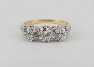 A lady's 18ct yellow gold dress ring set 3 circular diamonds and with 6 diamonds to the shoulders, approx 2.01ct