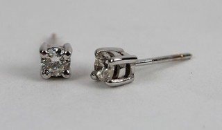 A pair of claw set diamond ear studs, approx 0.36