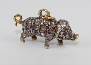 A gold charm in the form of a pig set diamonds and with ruby set  eyes