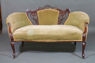 An Edwardian mahogany show frame sofa upholstered in green material raised on cabriole supports 60"