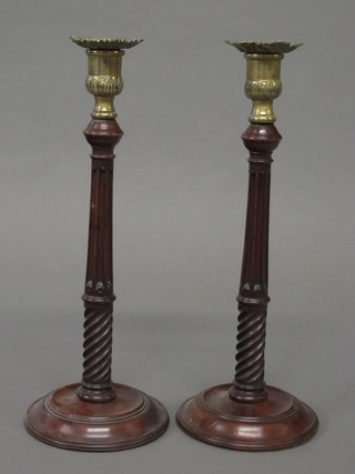 A pair of turned and fluted mahogany candlesticks with gilt metal  sconces 13"