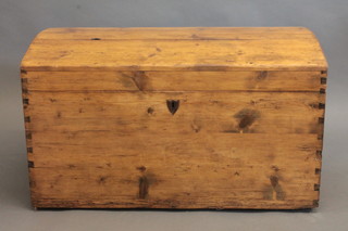 A 19th Century stripped and polished pine domed trunk with  hinged lid and iron drop handles 37"