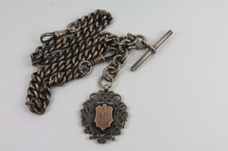 A silver double Albert curb link watch chain hung a medallion