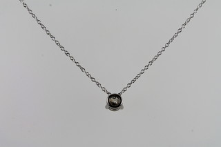 A solitaire diamond pendant hung on a fine gold chain