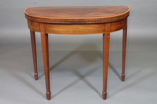 A Georgian mahogany demi-lune card table inlaid satinwood stringing, raised on square tapering supports 36"
