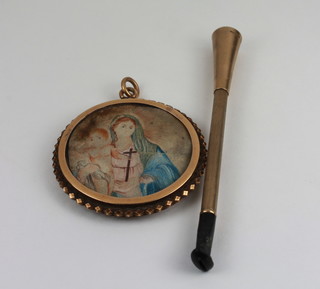 A 9ct gold cigarette holder together with a gilt framed pendant decorated the Holy Family