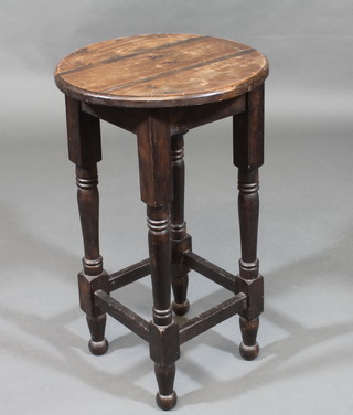 A circular pine occasional table, raised on turned and block supports 16"
