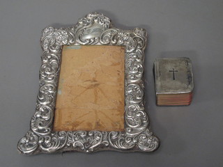 A silver easel photograph frame 5" x 3 1/2" and a silver covered  Common Book of Prayer