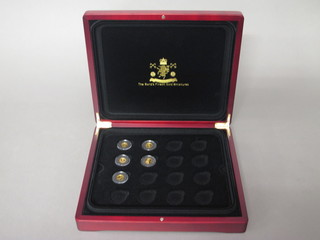 5 miniature gold coins contained in a mahogany case