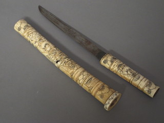 An Oriental dagger with 7 1/2" blade contained in a carved ivory sheath