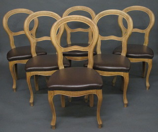 A set of 6 pine balloon back dining chairs, the seats of serpentine outline, raised on cabriole supports