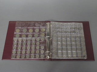 A ring bind album of various coins