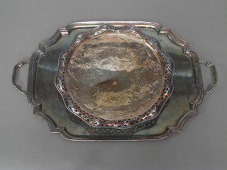 A silver plated twin handled tray with bracketed border and a circular silver plated salver with wavy and pierced border