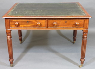 A Victorian mahogany library table with inset tooled green  leather writing surface, fitted 4 long drawers, raised on turned  and reeded supports 44"  ILLUSTRATED