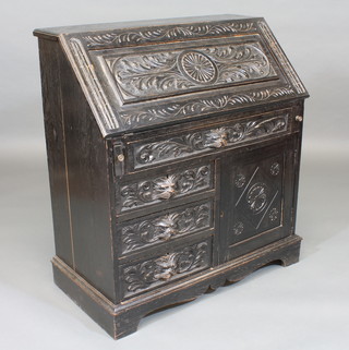 A Victorian carved ebonised bureau, the fall front revealing a well fitted interior, above 1 long and 3 short drawers flanked by  a cupboard, raised on a platform base 36"