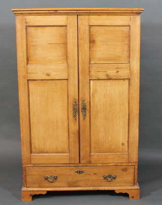 A 19th Century pine cabinet, the interior fitted shelves enclosed by panelled doors, the base fitted 1 long drawer, raised on  bracket feet 33"