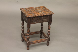 A rectangular carved oak joyned stool with hinged lid, the lid  carved 2 dolphins, raised on turned and block supports 14"