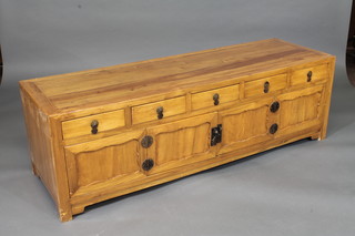 A rectangular Oriental hardwood cabinet fitted 5 short drawers  above a double cupboard enclosed by a panelled door 62"