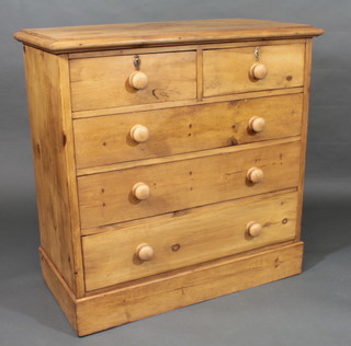 A stripped and polished pine chest of 2 short and 3 long drawers  with tore handles, raised on a platform base 40"