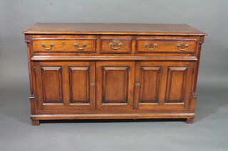 A Georgian Country oak dresser base with crossbanded top, fitted 1 short and 2 long drawers above a double cupboard enclosed by  panelled doors, raised on bracket feet 56"   ILLUSTRATED
