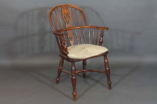 A yew and elm Windsor chair with cow horn stretcher