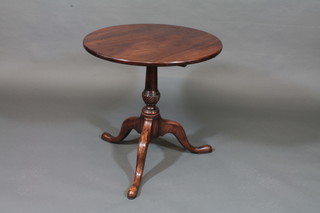 A 19th Century circular mahogany tea table, raised on a pillar  and tripod base 25"