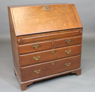An 18th Century Georgian oak bureau, the fall front revealing a  well fitted interior above 2 short and 2 long drawers, raised on  bracket feet 34"