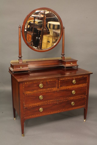 An Edwardian inlaid mahogany dressing table with circular  bevelled plate mirror, fitted 2 glove drawers above 2 short and 2  long drawers, raised on square tapering supports 40"
