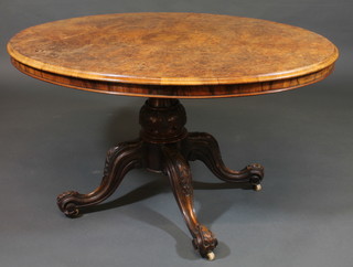 A Victorian oval figured walnut Loo table, raised on a turned  column and tripod base 48"