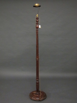 A turned and reeded mahogany standard lamp