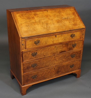 A Queen Anne style walnut bureau with fall front revealing a  well fitted interior above 4 long drawers, raised on bracket feet  36"