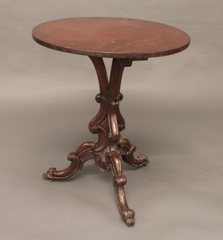 A circular mahogany occasional table, raised on a carved tripod  base 25"