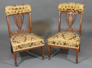 A pair of Victorian inlaid rosewood nursing chairs with  upholstered seats and back, raised on square tapering supports