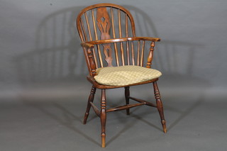 An elm Windsor carver chair with H framed stretcher