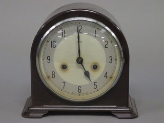 An Art Deco striking mantel clock with painted dial and Arabic numerals contained in an arch shaped Bakelite case by Enfield