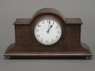 A bedroom timepiece with enamelled dial and Roman numerals  contained in an arch shaped mahogany case, raised on bun feet