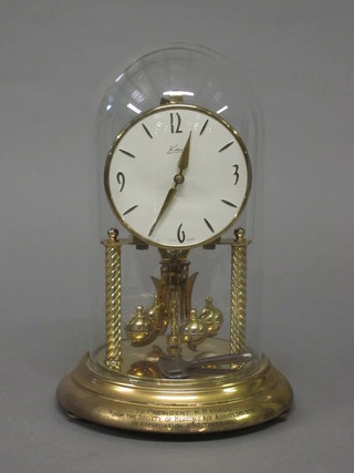A German 400 day clock with gilt dial and complete with dome