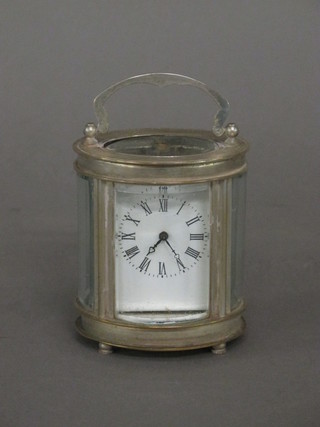 A reproduction miniature carriage clock contained in a gilt case  with enamelled panels 3"