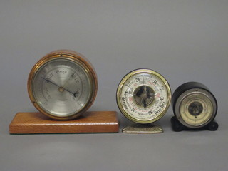 An aneroid barometer by Negretti and Zambra with silvered dial  contained in an oak case 4" together with 2 other small  barometers