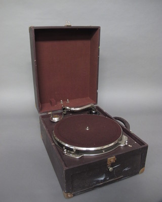 A manual gramophone contained in a fibre case