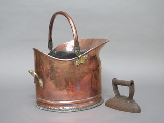 A copper helmet shaped coal scuttle and an iron flat iron